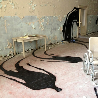 Illustration for article titled How do you make an abandoned asylum even creepier? Add eerie shadows